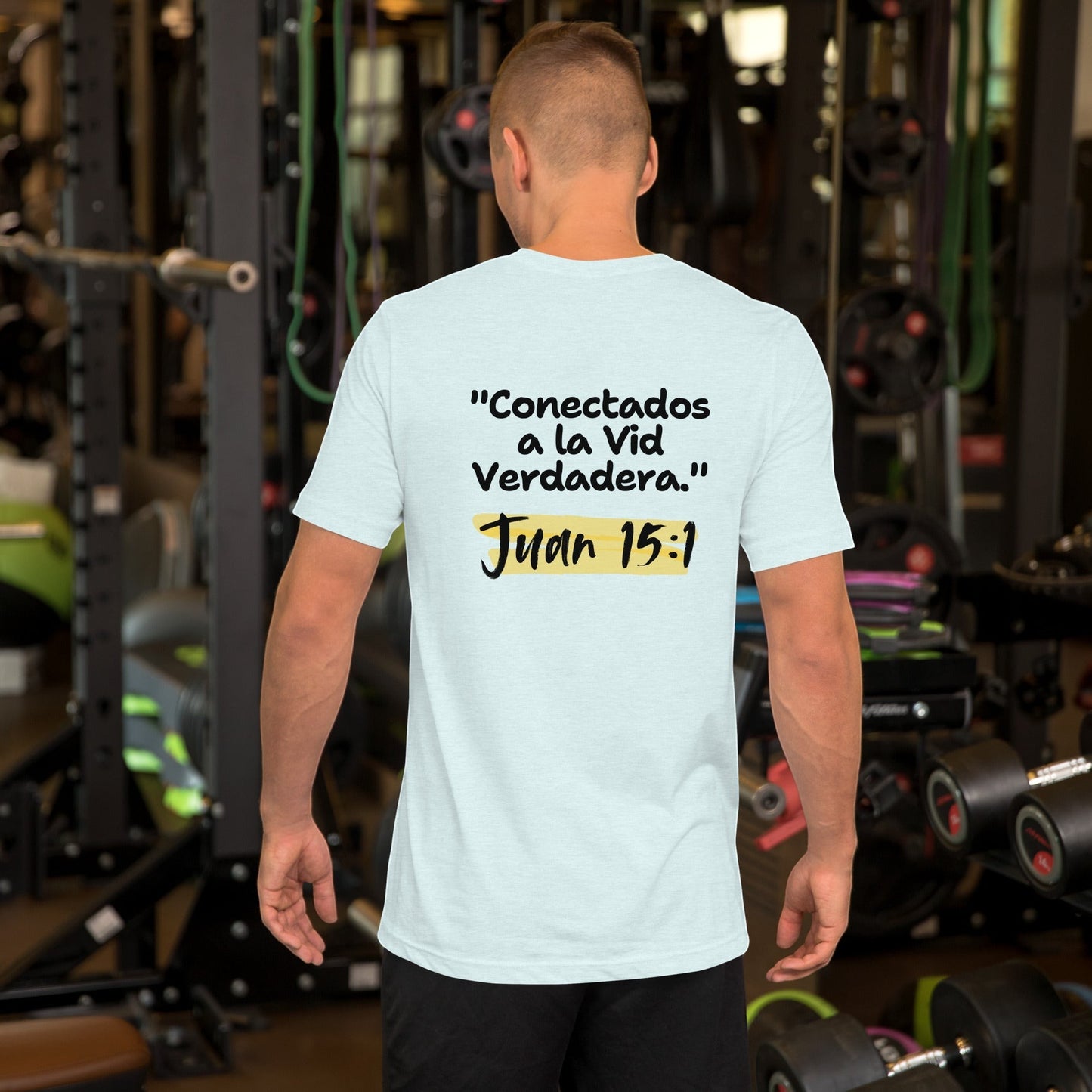 Crown & Cross Co light blue 100% cotton t-shirt with Spanish text "Conectados a la Vid Verdadera. Juan 15:1" on back. Model in gym.